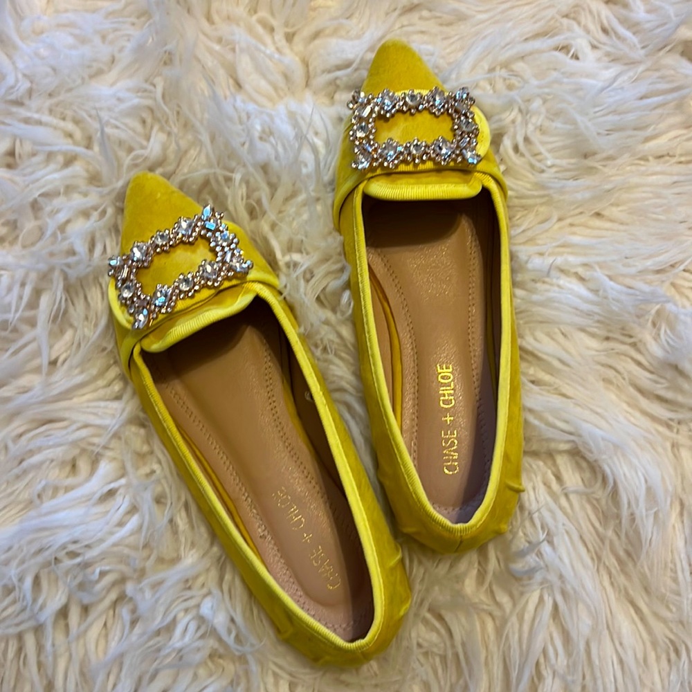 Yellow microsuede, pointed toe flats with rhinestone buckle.